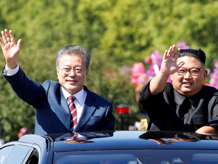 South Korean President Moon Jae-in and North Korean leader Kim Jong Un wave during a car parade in Pyongyang, North Korea