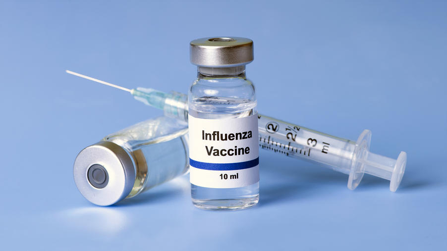 needle and bottle of flu vaccine
