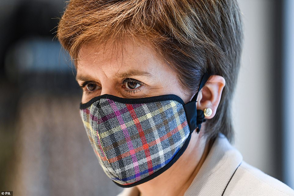 First Minister Nicola Sturgeon wears a Tartan face mask as she visits New Look at Ford Kinaird Retail Park in Edinburgh