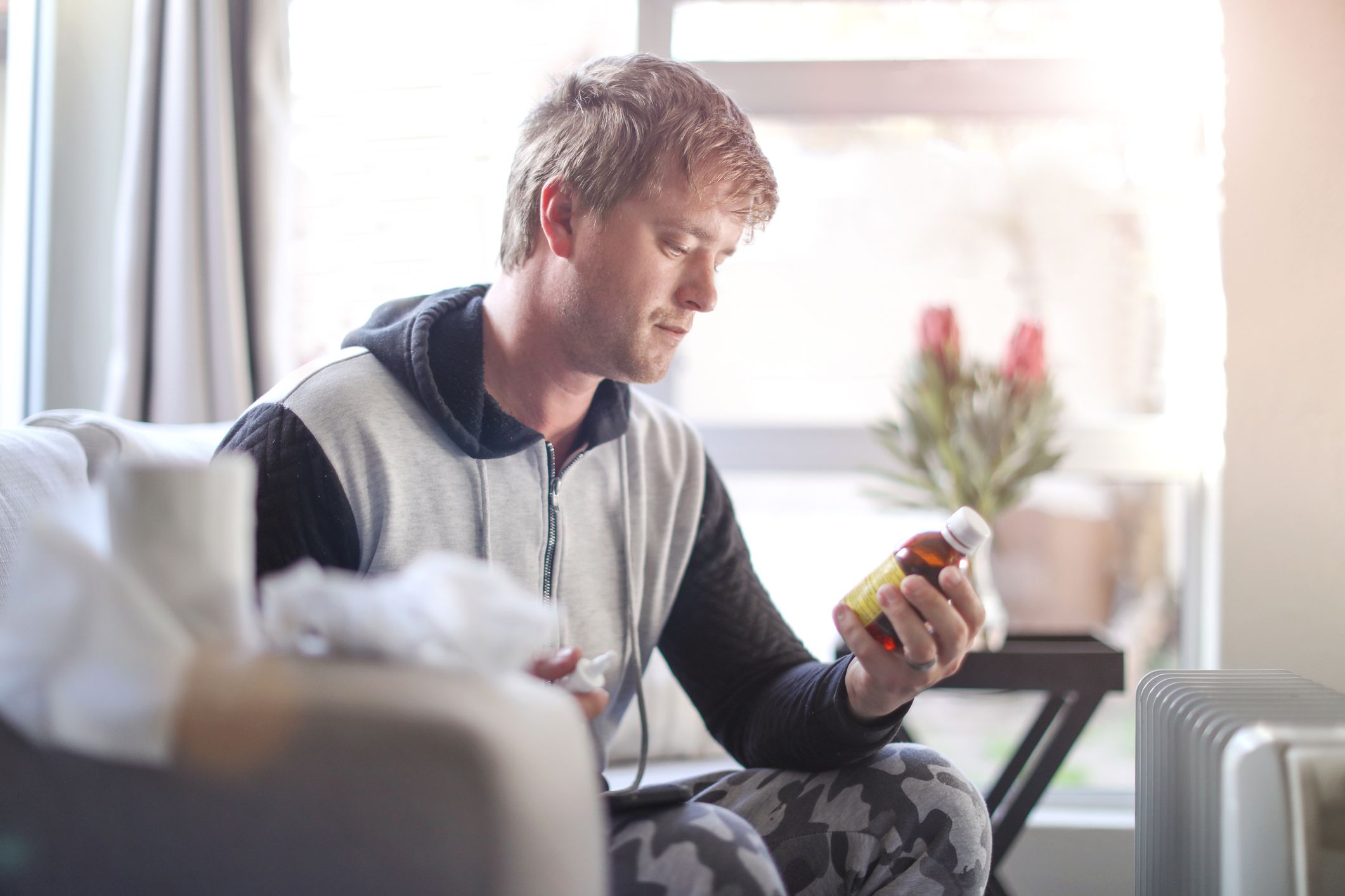 an adult male sick at home