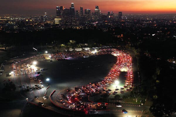Cars queued for a coronavirus test at Dodger Stadium in Los Angeles in December. A few weeks later, the site was converted into a mass vaccination site and local demand for testing plummeted.