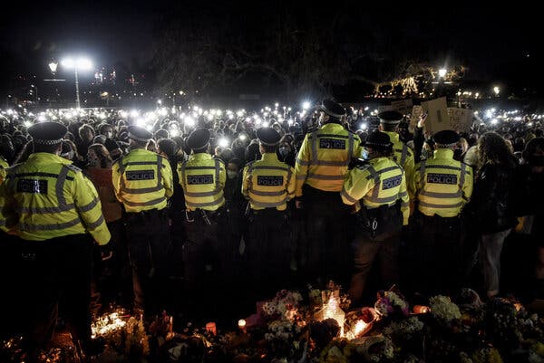 Smartphones shining as a sign of protest as police officers stood guard during Saturday’s vigil in Clapham Common, London.
