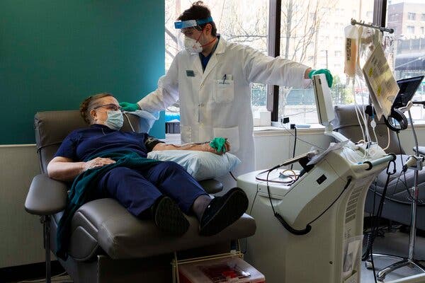 Brandon Connor, right, a phlebotomist, discussed the plasma donation process with Sheila Julich, a long-term-care nurse, at Bloodworks in Seattle in April 2020.