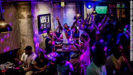 Soccer fans watch a match in Lisbon, Portugal, at a crowded bar on August 12.