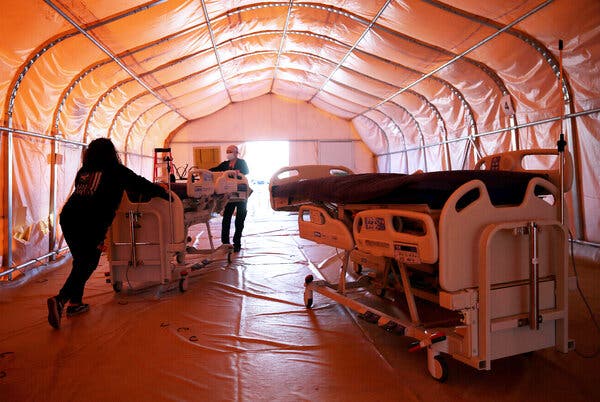 Medical technicians removed patient beds from an overflow tent in Apple Valley, Calif., in February after the number of Covid cases in the state dropped.