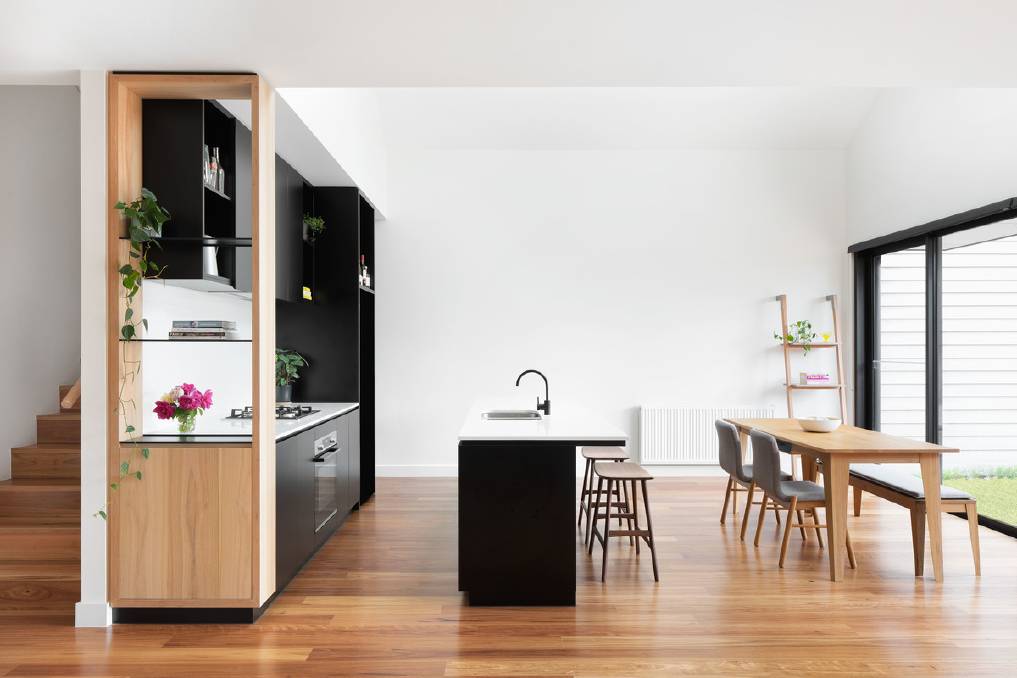 Minimalist style: The raked ceiling and overhead skylight in the kitchen bring in additional light. 