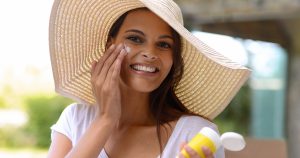 Woman putting on lotion