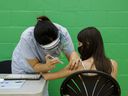 An adolescent receives a dose of the Pfizer-BioNTech Covid-19 vaccine at a clinic in Toronto, Ontario, Canada, on Wednesday, May 19, 2021.